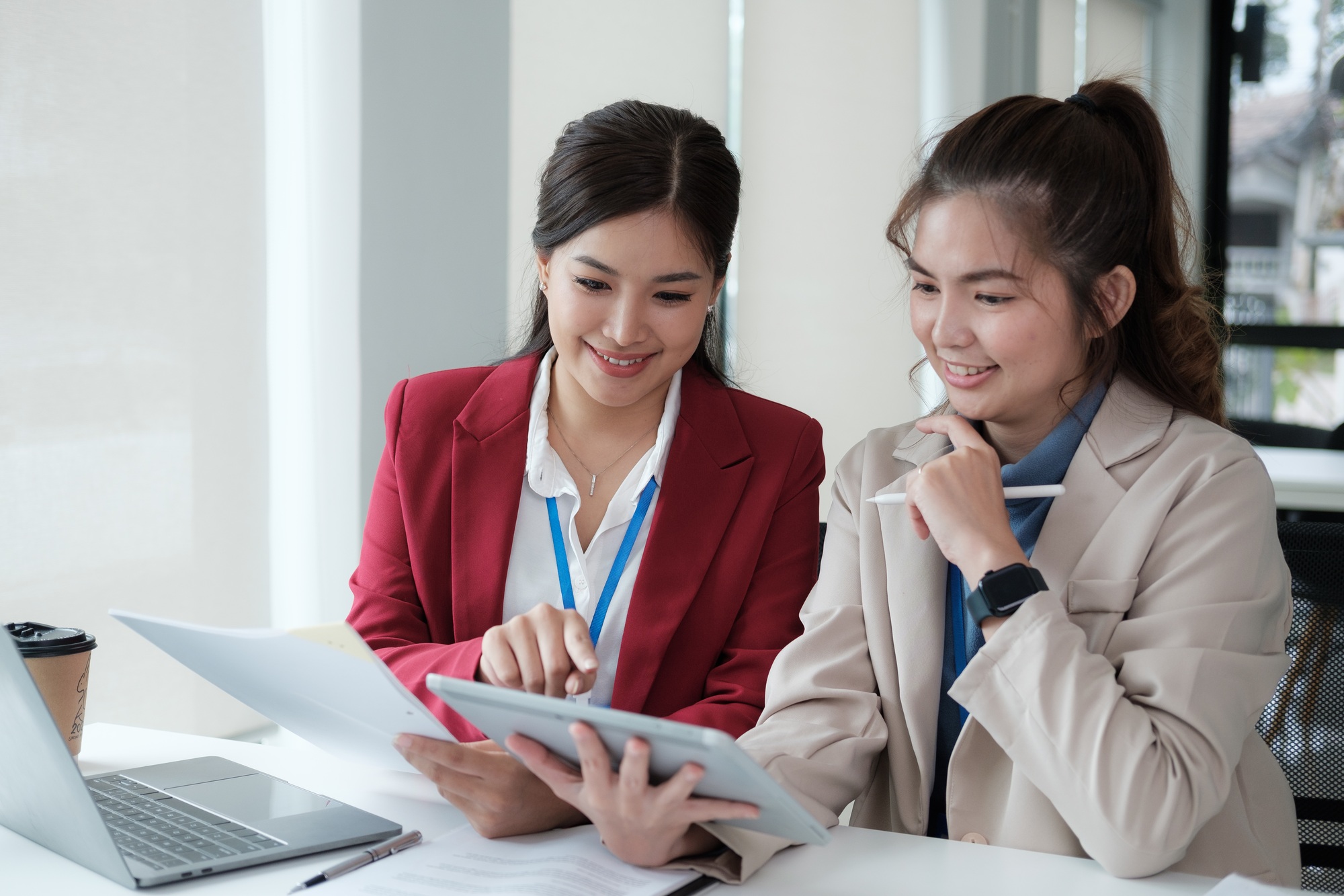 Two happy asian businesswoman talking and consulting working together in the office